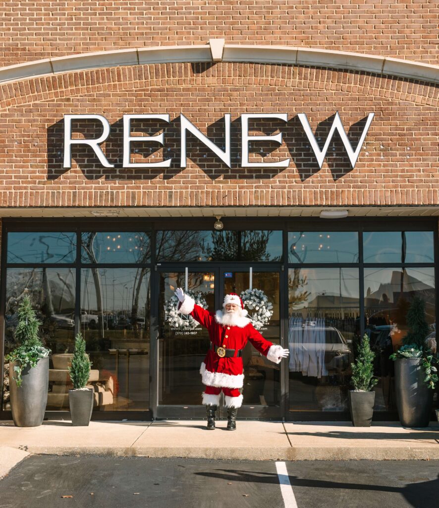 santa standing outside of renew